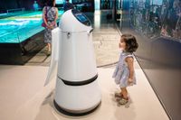  En guidande robot pratar med en liten nyfiken besökare på Seouls internationella flygplats Incheon.