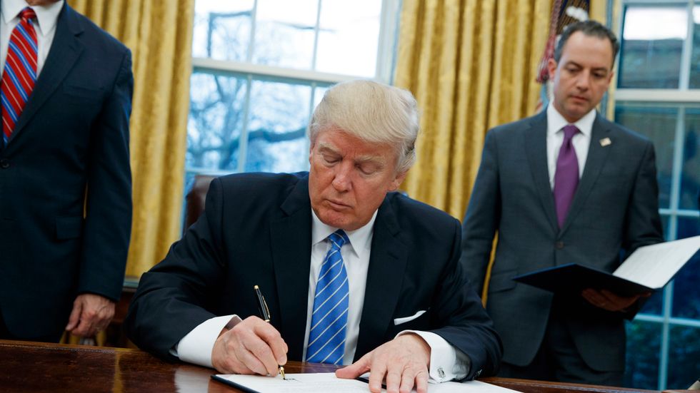   In this Monday, Jan. 23, 2017, file photo, President Donald Trump signs an executive order to withdraw the U.S. from the 12-nation Trans-Pacific Partnership trade pact agreed to under the Obama administration in the Oval Office of the White House in Washington. With his rejection of an Asian trade pact, Trump has started tackling policy changes that could inadvertently give China room to assert itself as a regional leader and worsen strains over the South China Sea and Taiwan 