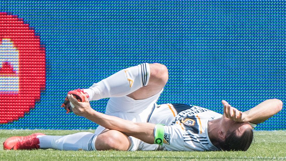  L.A. Galaxy's Zlatan Ibrahimovic lies injured during first-half MLS soccer game action against the Montreal Impact in Montreal, Monday, May 21, 2018. 