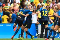 Sveriges Lotta Schelin och Lisa Dahlkvist kramas efter att ha gått vidare till final efter fyra satta straffar, mot Brasiliens tre.