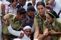 Kvinnor ur organisationen Damas de Blanco förs bort av polis inför Barack Obamas besök i Kuba.