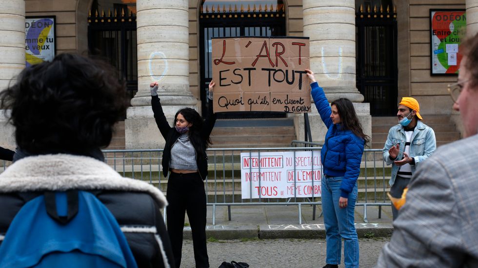 "Konsten är allt" står på plakatet som arbetslösa kulturarbetare håller utanför den ockuperade Théâtre Odeon i Paris. Arkivbild.
