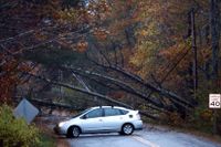 Över en miljon kunder är strömlösa på grund av en storm som dragit in över de nordöstra delarna av USA. På bilden nerblåsta träd som blockerar en väg i Maine.
