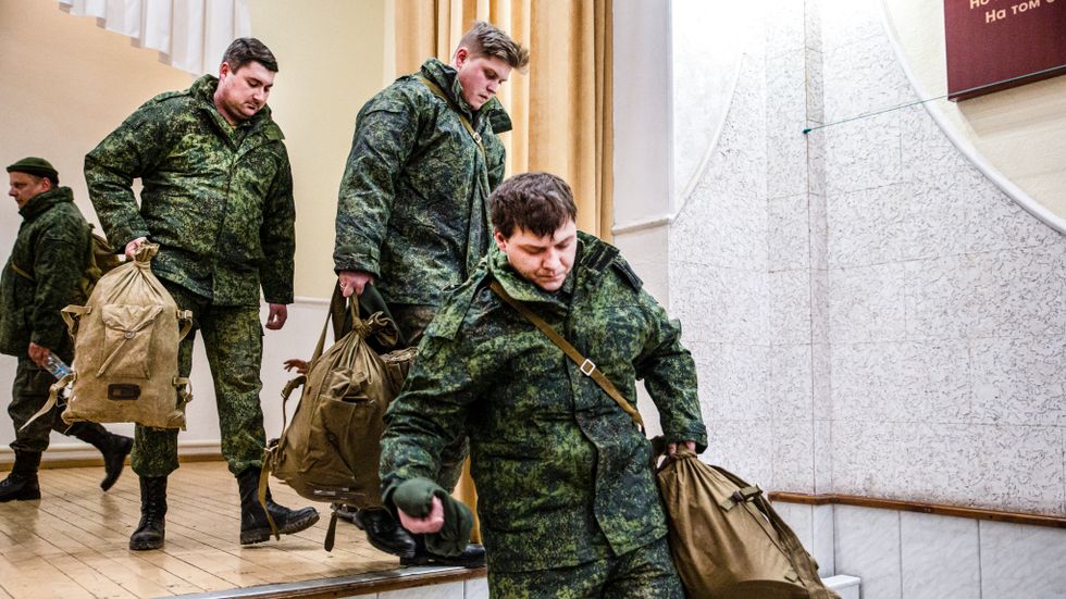 Volontärer tar emot utrustning på en militäranläggning i Luhansk.