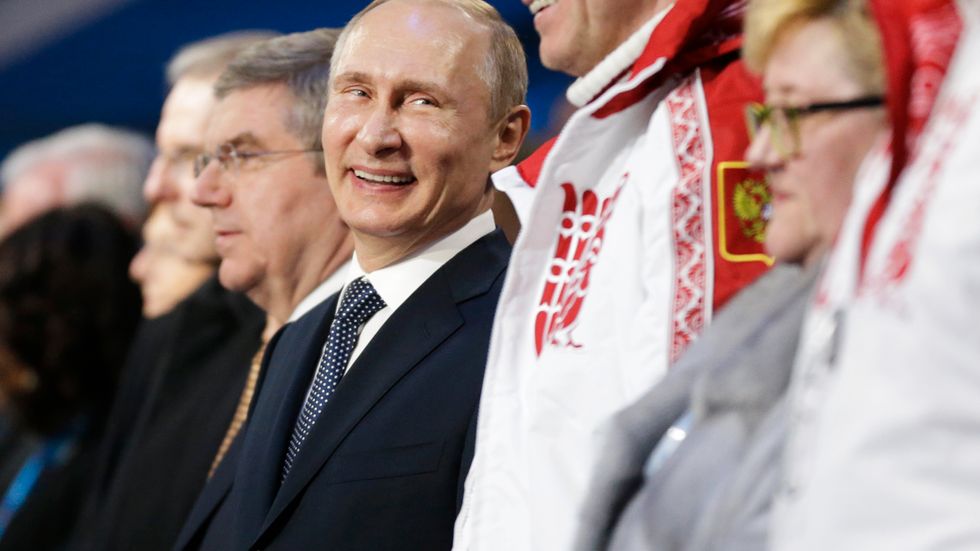 Putin står bredvid Alexander Zubkov, som vann guld i tvåmanna och fyrmanna-bobsled i vinter-OS i Sotji 2014. Zubkov är en av dem som misstänks ha dopat sig i det statliga ryska dopningsprogrammet.
