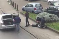 Belgisk polis griper en man på fredagen. Bilden är hämtad från en video.