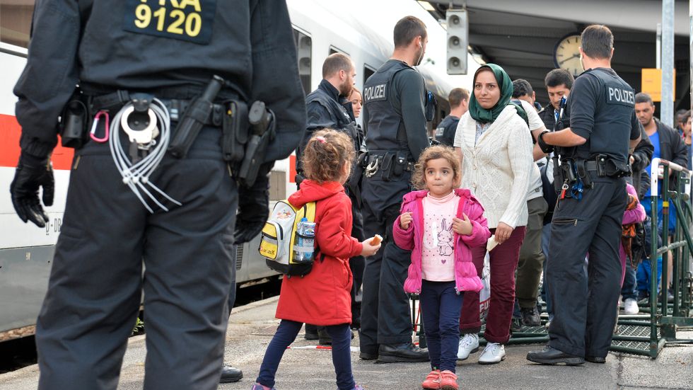 Flyktingar väntar på ett tåg i Freilassing, södra Tyskland, i närheten av den österrikiska gränsen.