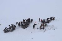 Räddningspersonal gräver i snön vid minst tre omkullvälta fordon efter lavinen i Bahçesaray i östra Turkiet.