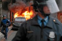 En limousin sattes i brand av demonstranter i Washington.