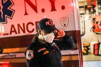 En ambulanssjukvårdare, Elizabeth Bonilla, torkar en tår bredvid sin ambulans i Bronx, New York, i april 2020. ”jag är känslomässigt och fysiskt slut just nu”, sa hon då till nyhetsbyrån AP.
