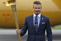 David Beckham poserade villigt med den olympiska facklan när den kom till Storbritannien i maj, men han vill inte tända elden på invigningen.