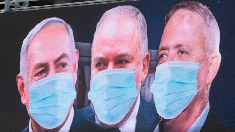 Israels premiärminister Benjamin Netanyahu till vänster och Benny Gantz till höger på en reklamskärm i Ramat Gan. I mitten står partiledaren Avigdor Lieberman, som agerar vågmästare eller bromskloss i knesset. Arkivbild.