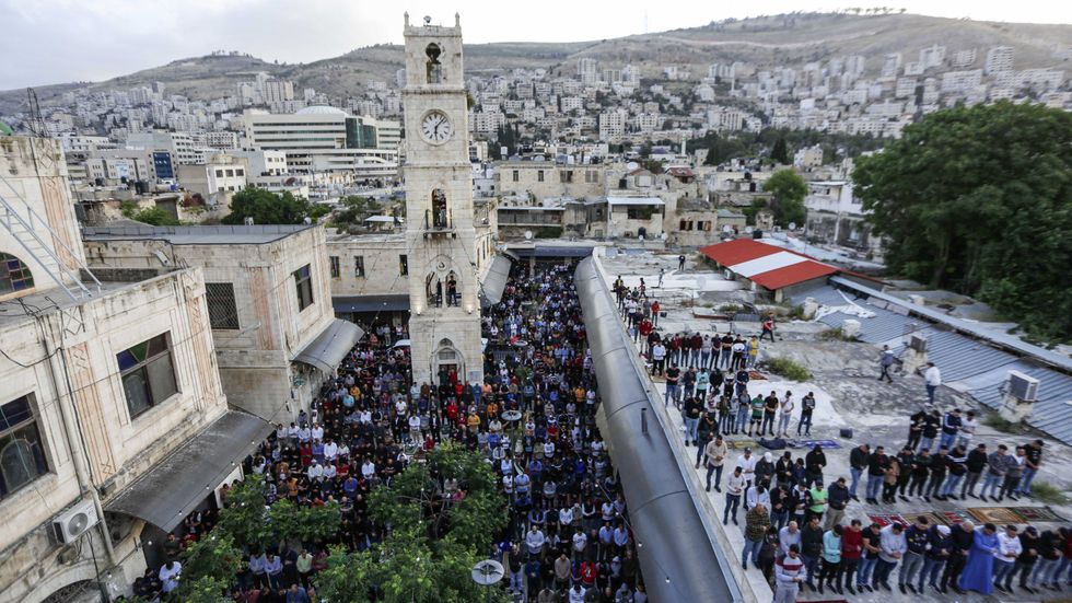 Palestinier ber i staden Nablus på Västbanken, den 24 maj i år, för att fira Eid al-Fitr. 