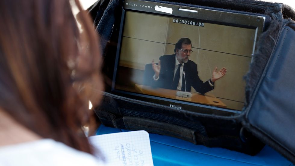 Spaniens premiärminister Mariano Rajoy under utfrågningen i rätten. Här via monitor utanför domstolen.