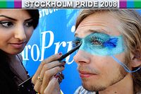 Prideparken i Tantolunden i Stockholm öppnade på onsdagen. Liza Odish sminkade Olof Norelid innan han skulle dela ut gratis isglass.