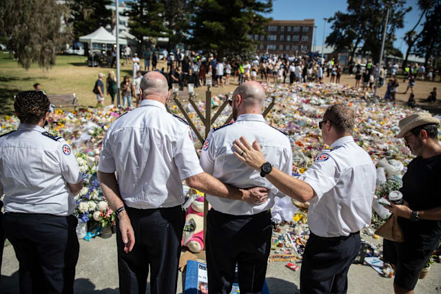 Ambulance paramedics honor the victims.