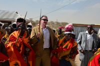 Alex Budden, chef för externa relationer på Africa Oil, dras med i en dans med en grupp inhyrda dansare när han anländer till Lodwar i Turkana.